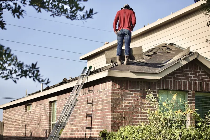 Professional roofer working on a residential roof in Isles at Wellington